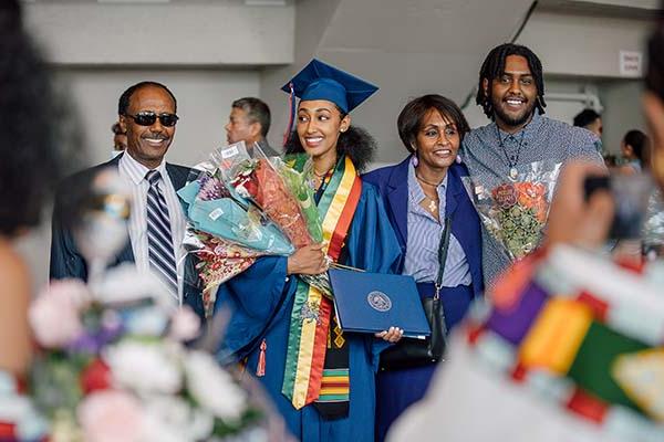 An MSU Denver graduate at Commencement with her family.