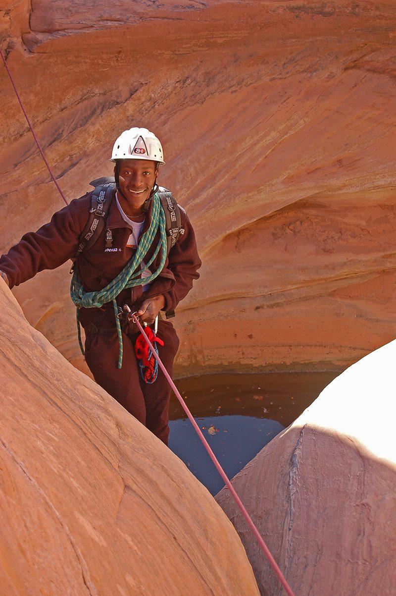 Man rappelling into canyon